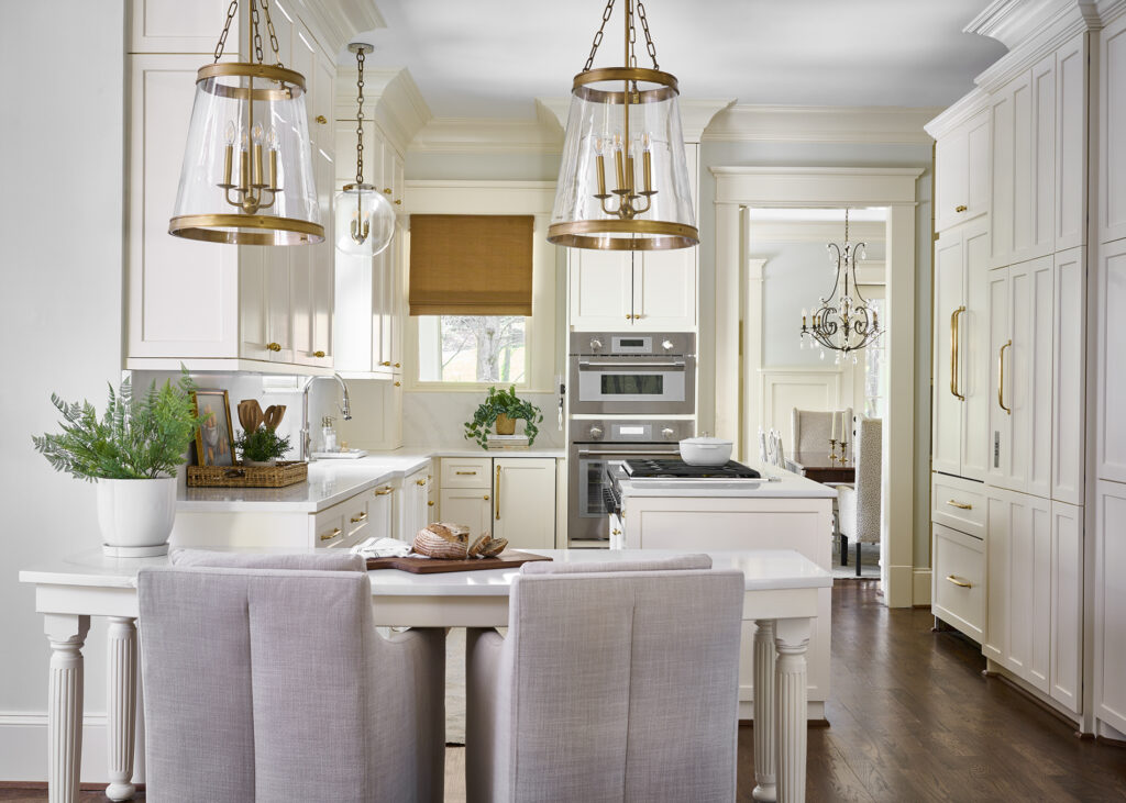 Photo of traditional kitchen showing the use of brass light fixtures and brass hardware by Atlanta interior designer.